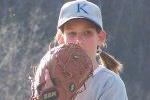 Girl pitcher looking in for the call.